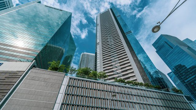Low-angle view of modern glass office towers in Singapore’s central business district